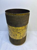 Front view of cylindrical metal wastebasket