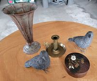 Overall lot showing vase, candlestick, two stone birds, coaster container