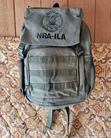 Front view showing logo, flap, webbing, side pockets