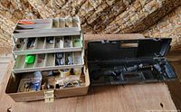 Open Plano tackle box beside open Zebco tackle tote showing collapsed rod