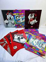 Group shot of all ten Coca-Cola graphic folders, fronts and backs visible