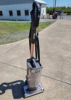 Full view of Shark Vertex upright vacuum cleaner standing on pavement