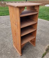Front angled view of pine wooden shelf showing four shelves and scroll brackets