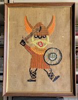 Front view of framed embroidered Viking artwork