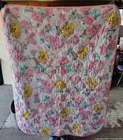 Full view of front side of quilted Tweety Bird blanket hanging
