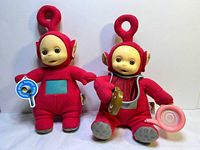 Both 15" Po plush dolls side by side