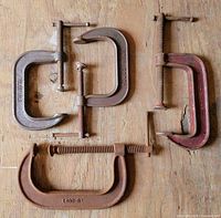 All four C-clamps laid out for size and condition reference