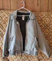 Front view of Carhartt jacket on hanger showing full design