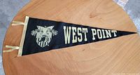 Full view of black felt West Point pennant with crest and ties