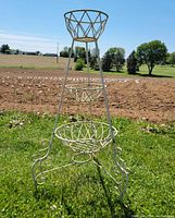 Full front view of metal three-tier plant stand