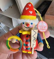 Front view of wooden Steinbach ornament showing figure details and tag
