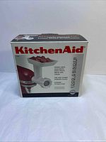 Front view of boxed KitchenAid food grinder attachment model FGA