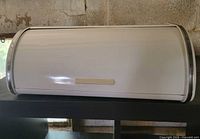 Front view of white Brabantia roll-top bread box closed