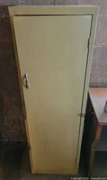 Front view of closed beige metal cabinet