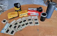 Group shot of all slides, viewers, storage items on table
