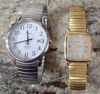 Both Timex wristwatches side by side on surface