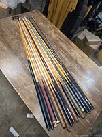 Full group of pool cues lying on table