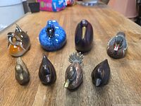 All eight duck figurines grouped on table