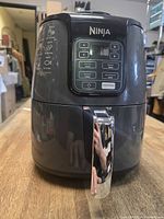Front view of Ninja AF101 air fryer showing digital control panel and chrome handle
