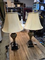 Full view of both matching table lamps on table, showing bases, shades and cords
