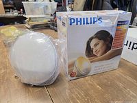 Boxed Philips wake-up light with unit beside packaging