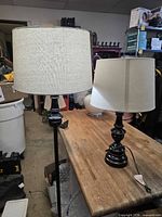 Both lamps side by side on workbench showing bases and shades