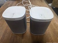 Front view of both Sonos Play:1 speakers with attached power cables