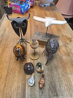Group shot of all nine bird figurines on wooden surface