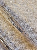 Stamped True Temper Kelly Works Woodsman marking on wooden axe handle