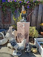 Overall view of pedestal with multiple rooster statues