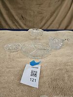 Group shot of four pressed glass pieces on towel