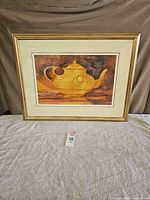 Yellow teapot still-life print in gold frame