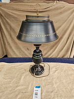 Full view of black metal table lamp on towel