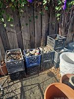 Five stacked milk crates filled with assorted rocks