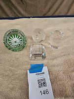 Four glass items grouped on cloth surface