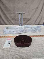 All three items grouped: metal candle holder at back, faux log planter in middle, lacquer bento box in front