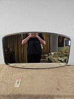 Full view of metal framed mirror on table