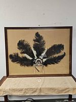 Full view of framed headdress on beige backing
