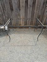 Full view of rectangular metal table frame without top