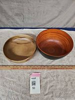 Top view of both bowls showing interior finishes and relative size with ruler