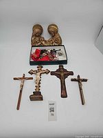 Group shot showing sculpture, crosses, rosaries
