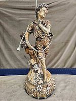 Full view of boy statue lamp showing overall form and cord