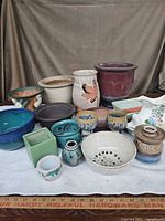 Group view of all fifteen ceramic items laid out on table