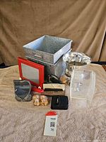 Group shot of all miscellaneous items including bin, Etch A Sketch, bowl, organizer, frame, trowel, wallet, case, figurines, clamp