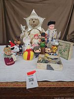 Overview of all dolls and figures on table