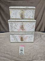 Three floral satin boxes stacked showing overall condition and pattern