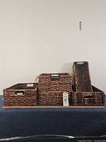 All four wicker baskets side by side showing scale and condition