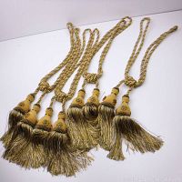 Four gold braided curtain tie backs displayed showing full length including tasseled ends.