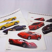 Collection of several Ferrari car sticker sheets with some partially overlapping, showcasing a range of models in bright colors.