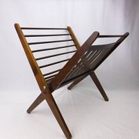 Full view of the MCM wooden folding magazine holder showing the open X-shaped frame and slatted sides.